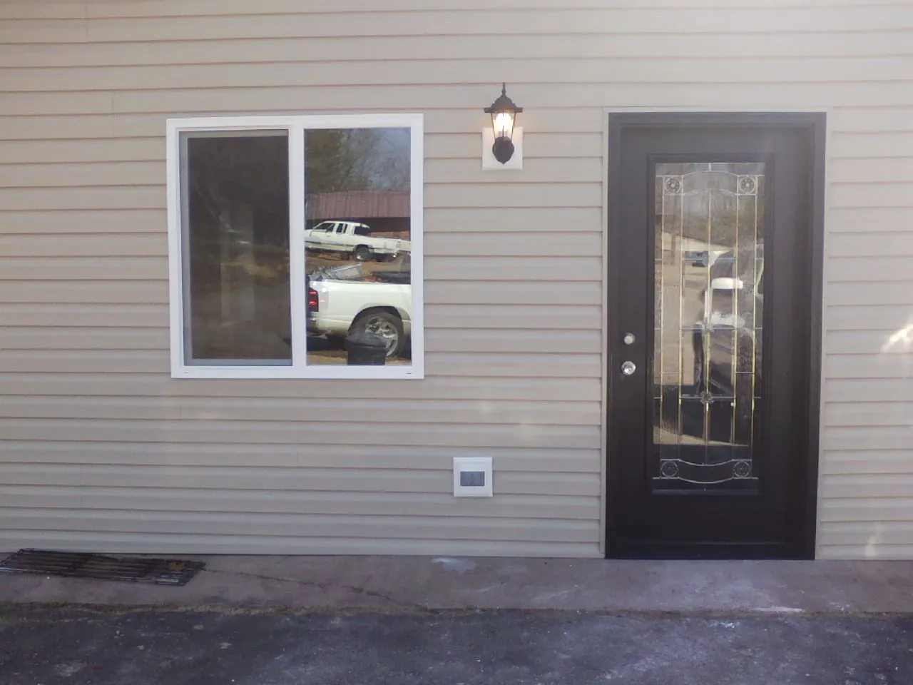 New siding, window and entry door on the side of an addition in Linville