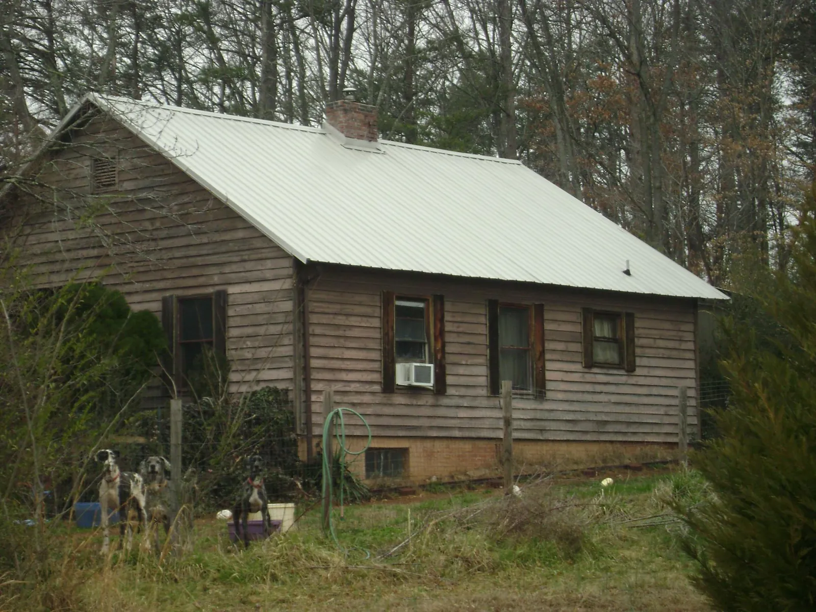 White metal roof on an old wood sided farmhouse, from a Metal Roof Installation job in Linville
